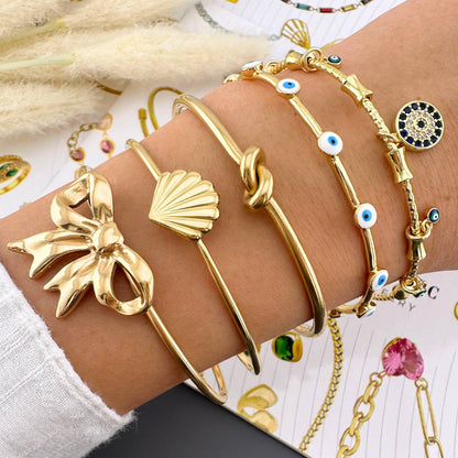 GONOSZ SZEMEK KARKÖTŐ, 18K  ARANYOZOTT NEMESACÉL