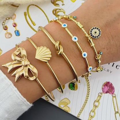 GONOSZ SZEMEK KARKÖTŐ, 18K  ARANYOZOTT NEMESACÉL